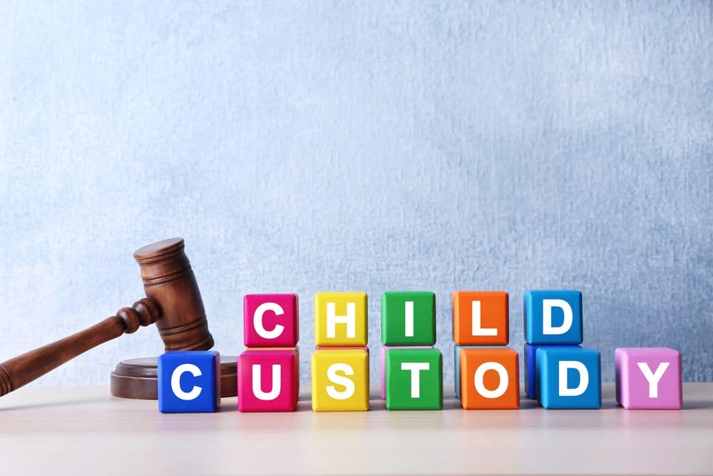 Calgary Child custody lawyers developing parenting and child access plans portrayed by lettered blocks spelling out child custody alongside a gavel